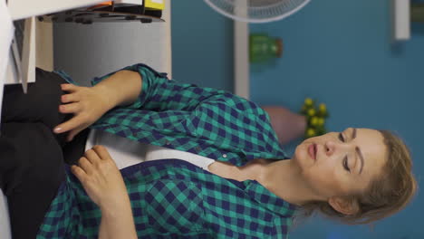 Vertical-video-of-Home-office-worker-woman-is-suffocating-from-hot-weather.